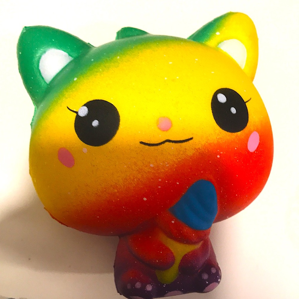 Multicolored cat holding ice cream cone squishy